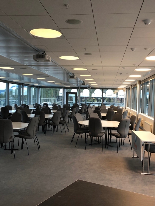Stor konferansesal med store vinduer, utstyrt med innvendig og utvendige persienner.